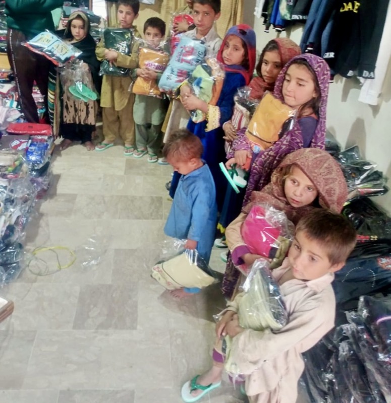 Children holding new clothing parcels