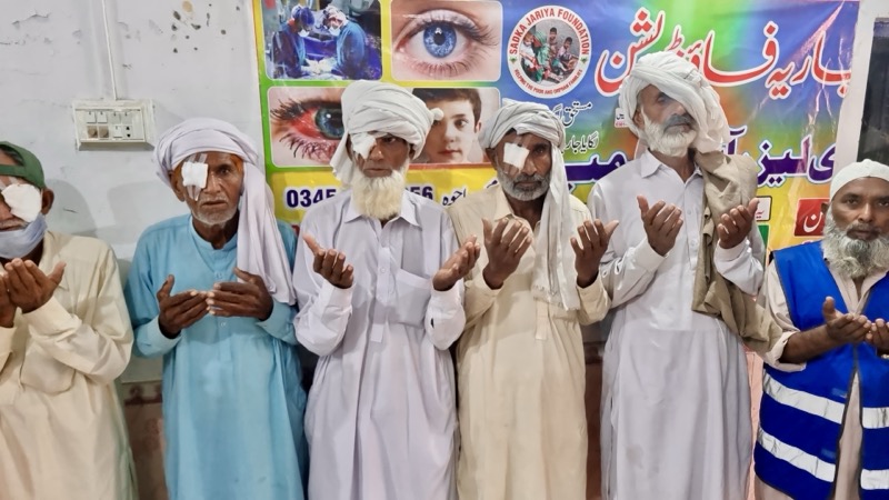 Men giving thanks after free cataract surgery at an eye camp