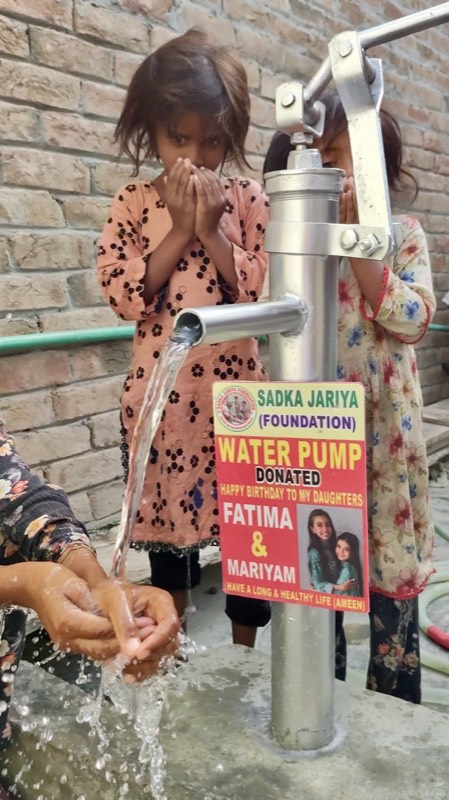 A child drinking clean water from a new pump